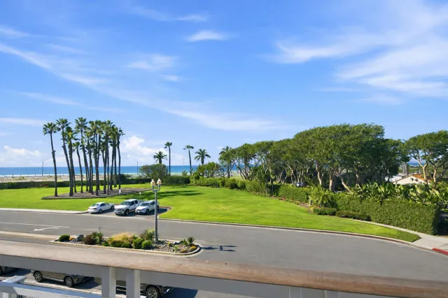 a view of a stadium that has a big yard and a large tree