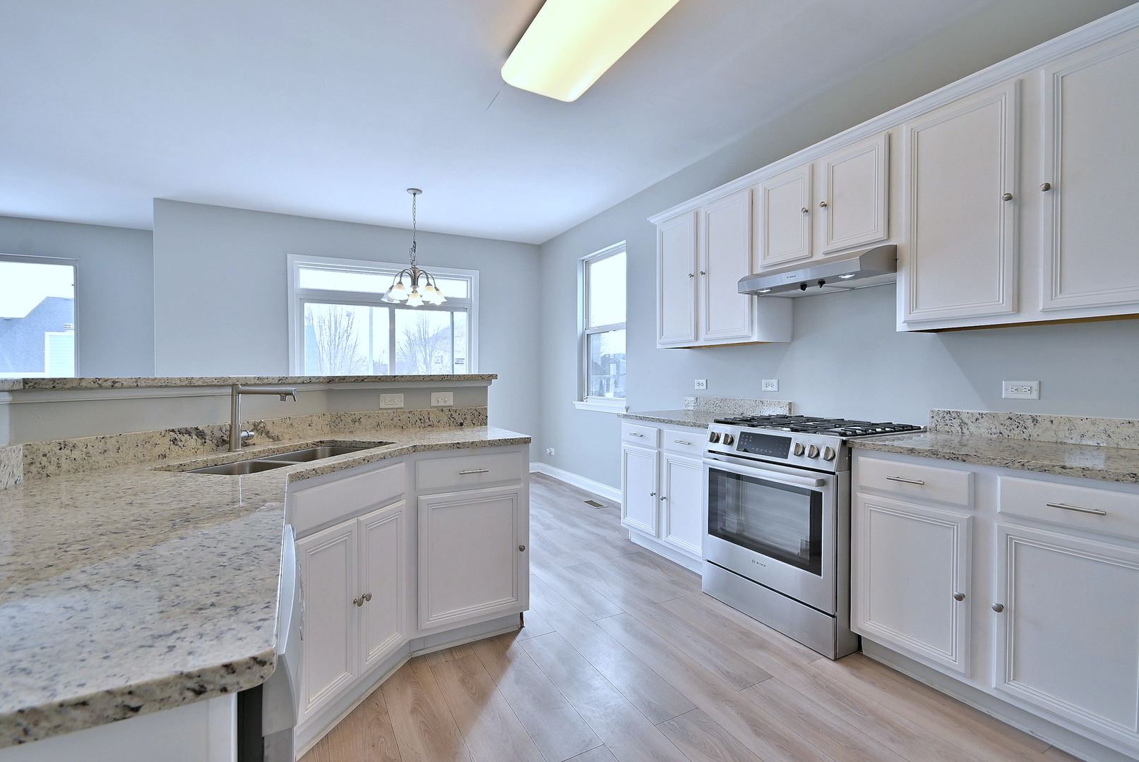 233 Pawtucket Avenue Elgin, IL 60124 - Photo 11 of 49 a kitchen with granite countertop a sink a stove and cabinets