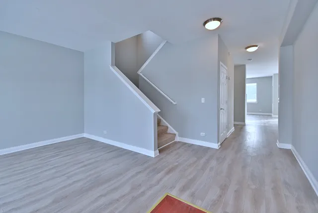 a view of a kitchen with center island and wooden floor