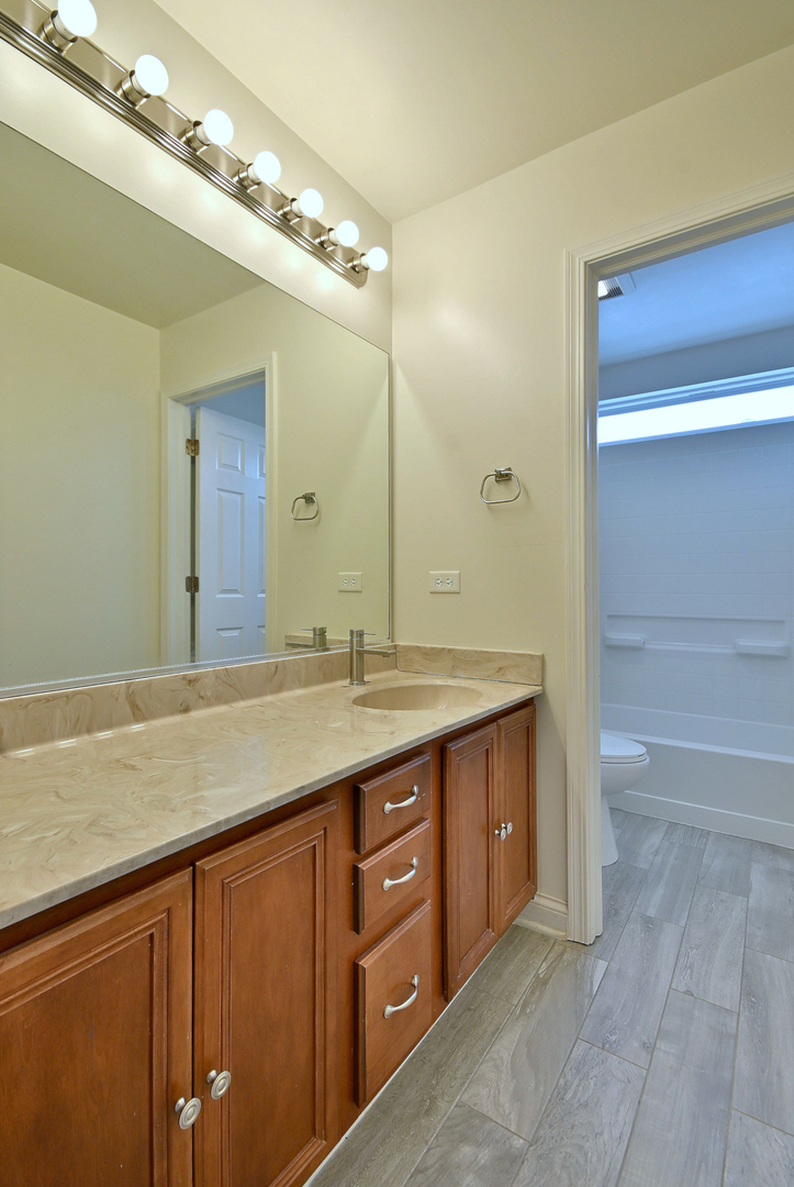 233 Pawtucket Avenue Elgin, IL 60124 - Photo 35 of 49 a bathroom with a granite countertop sink and a mirror