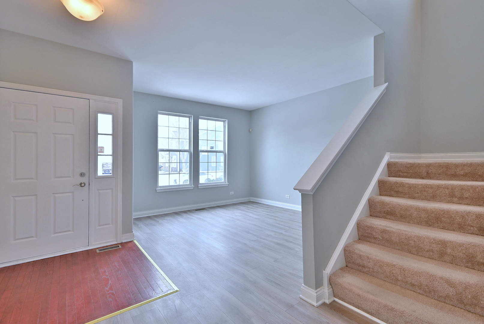 233 Pawtucket Avenue Elgin, IL 60124 - Photo 4 of 49 a view of an empty room with wooden floor and stairs