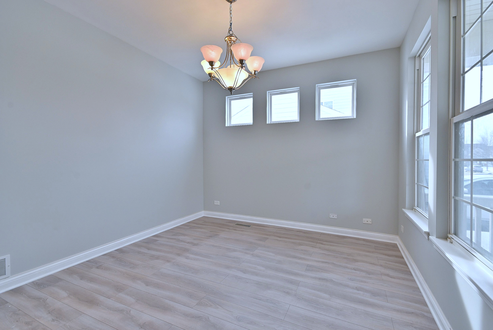 233 Pawtucket Avenue Elgin, IL 60124 - Photo 7 of 49 wooden floor in an empty room with a window