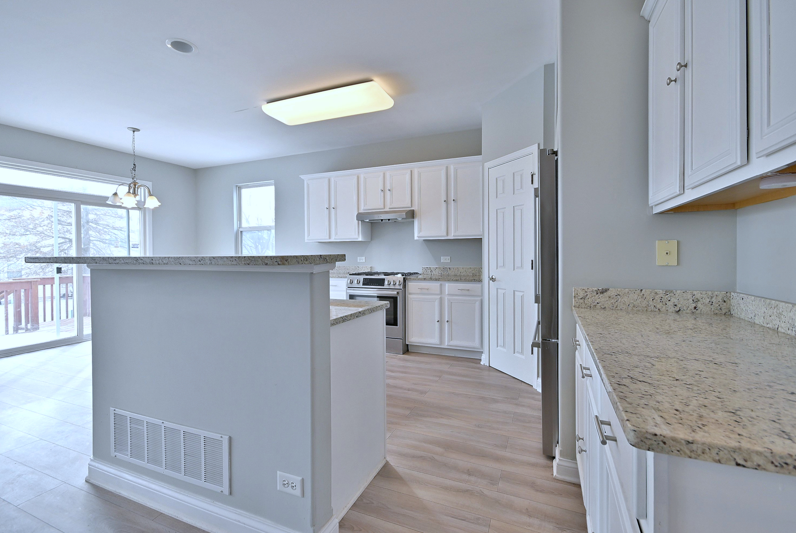 233 Pawtucket Avenue Elgin, IL 60124 - Photo 8 of 49 a kitchen with granite countertop a sink stove and refrigerator