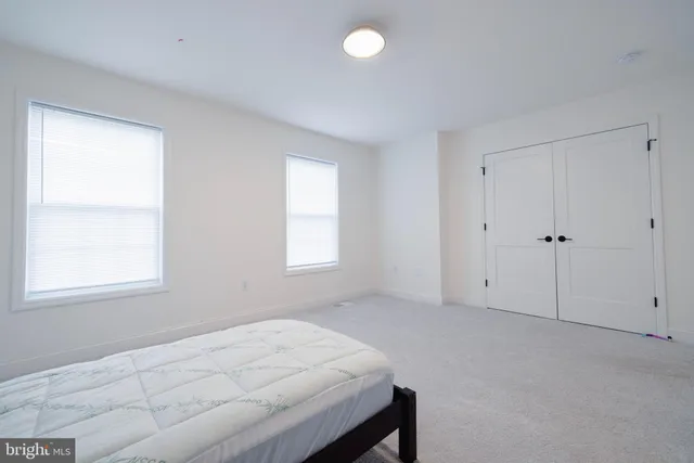 a room that has a bed and a window in it
