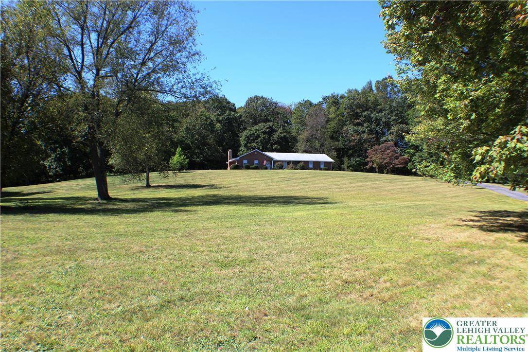 909 Wood Road Danielsville, PA 18038 - Photo 1 of 56 a view of a field with trees in the background