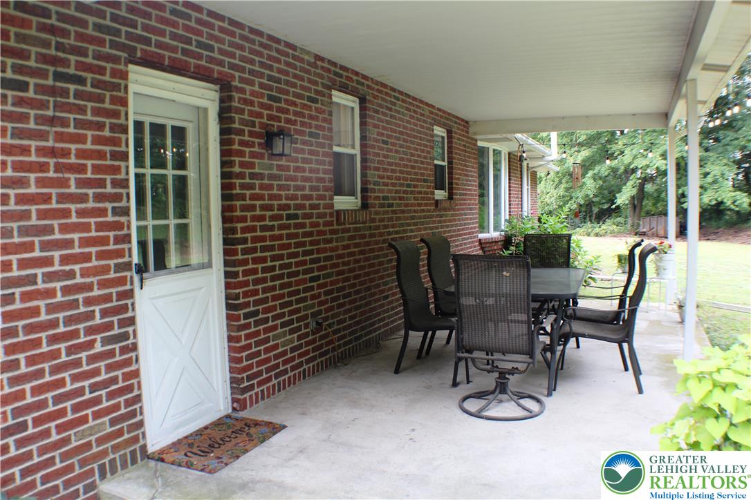909 Wood Road Danielsville, PA 18038 - Photo 14 of 56 a view of a patio with table and chairs and potted plants