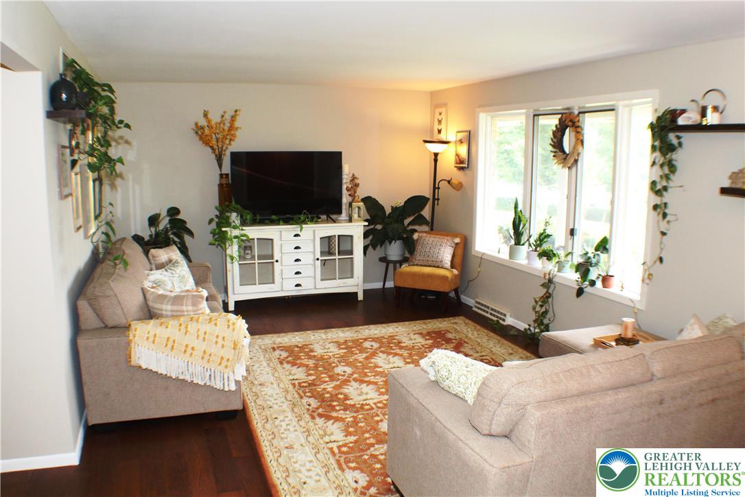 909 Wood Road Danielsville, PA 18038 - Photo 15 of 56 a living room with furniture and a flat screen tv