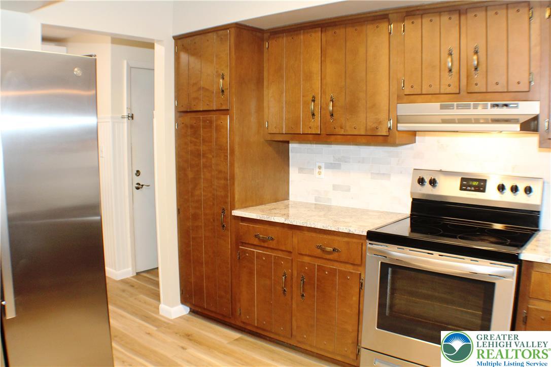 909 Wood Road Danielsville, PA 18038 - Photo 23 of 56 a kitchen with granite countertop cabinets stainless steel appliances and a counter space