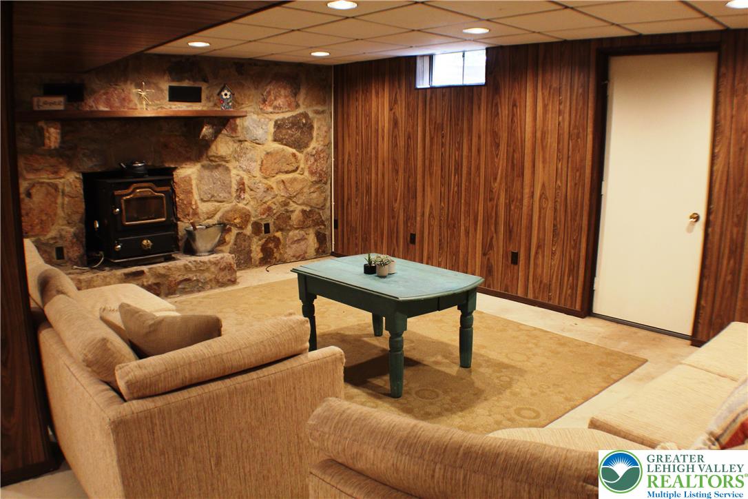 909 Wood Road Danielsville, PA 18038 - Photo 28 of 56 a living room with furniture and a fireplace