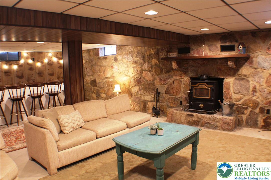 909 Wood Road Danielsville, PA 18038 - Photo 30 of 56 a living room with furniture and a fireplace
