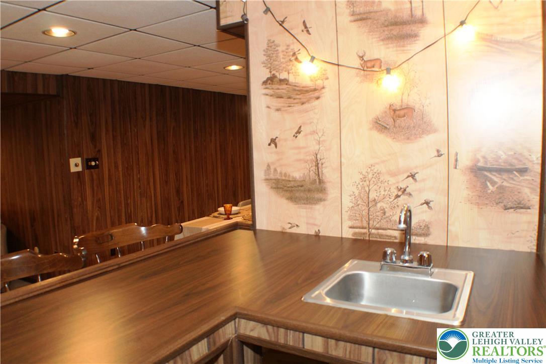 909 Wood Road Danielsville, PA 18038 - Photo 33 of 56 a bathroom with a sink and a large mirror