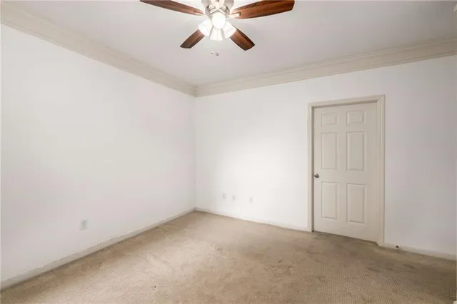 an empty room with chandelier fan