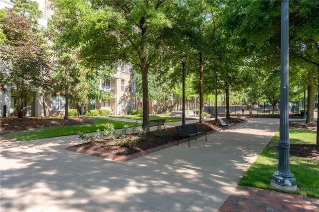 a view of a patio with dining table and chairs and potted plants