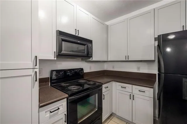 a kitchen with a stove microwave and sink