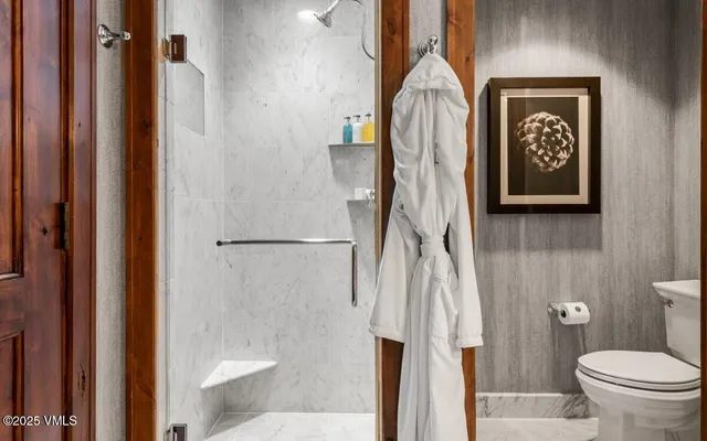 a bathroom with a toilet a sink and vanity