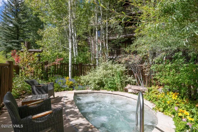 a view of a backyard with sitting area and garden