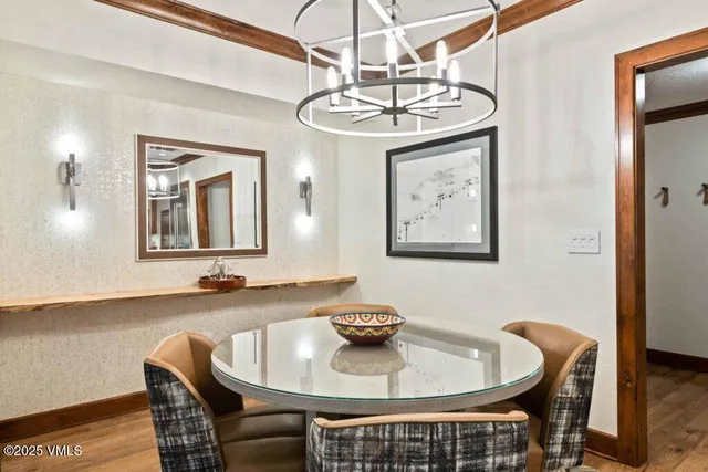 a view of a dining room with furniture and chandelier