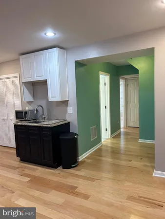 a kitchen with granite countertop wooden cabinets and granite counter tops