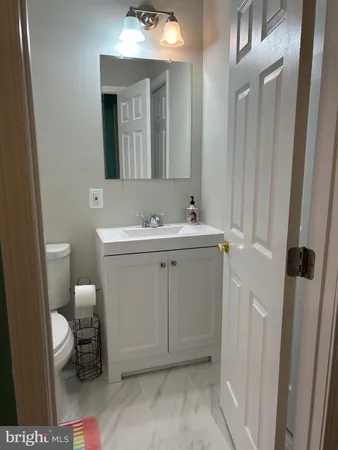 a bathroom with a toilet sink and mirror