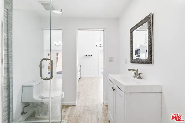 a bathroom with a toilet a sink and a mirror