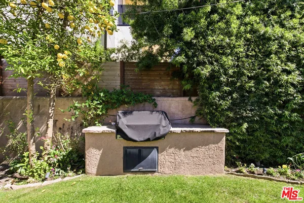 a view of a chair and table in backyard