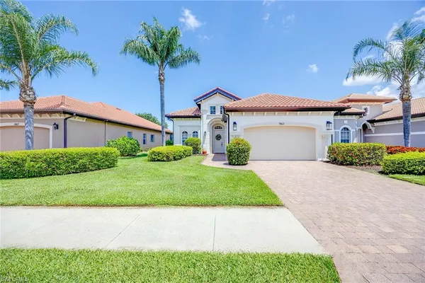a front view of a house with a yard and garage