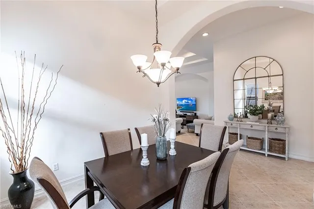 a view of a dining room with furniture and a chandelier