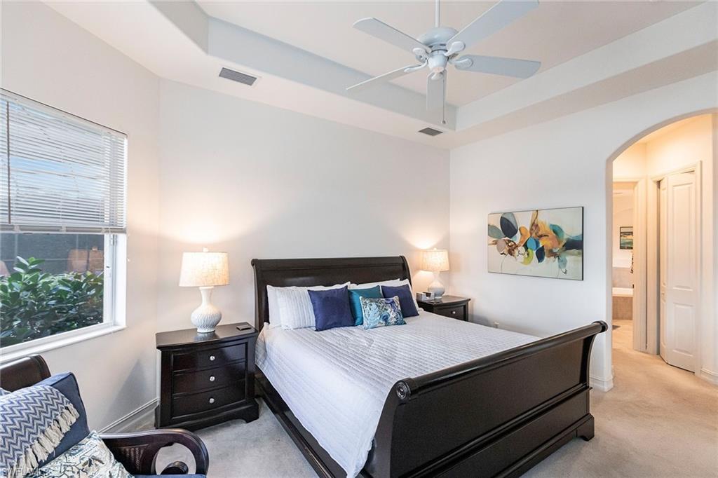 7863 Valencia Court Naples, FL 34113 - Photo 21 of 50 a bedroom with a bed and window