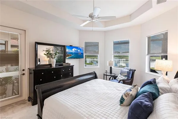 a bedroom with a bed a mirror and furniture