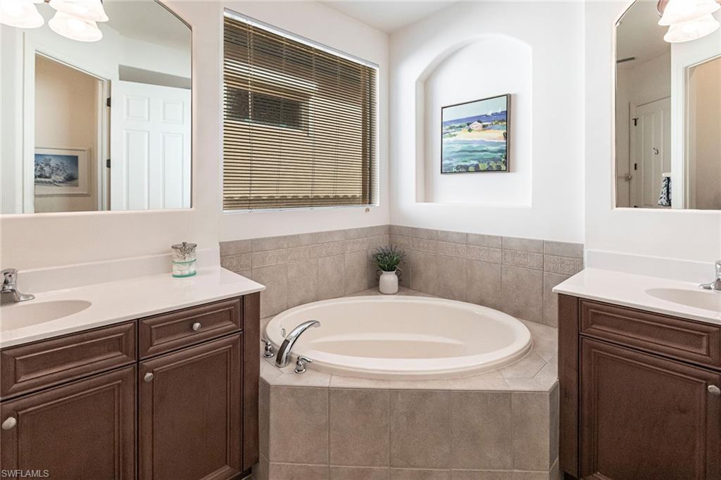7863 Valencia Court Naples, FL 34113 - Photo 26 of 50 a bathroom with a sink a toilet and mirror