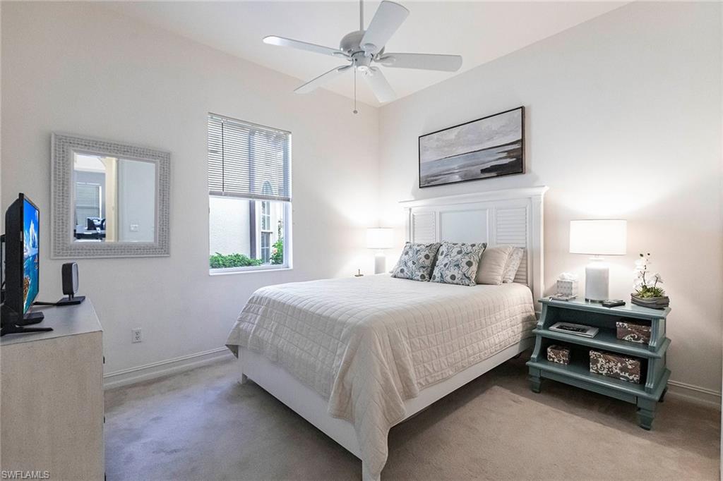 7863 Valencia Court Naples, FL 34113 - Photo 29 of 50 a bedroom with a bed a dresser and flat screen tv