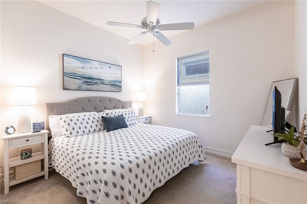 7863 Valencia Court Naples, FL 34113 - Photo 32 of 50 a bedroom with a bed and a flat screen tv