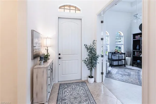 a view of a hallway and a livingroom with furniture