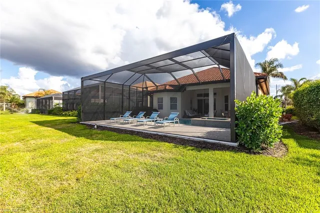 a view of house with swimming pool outdoor seating