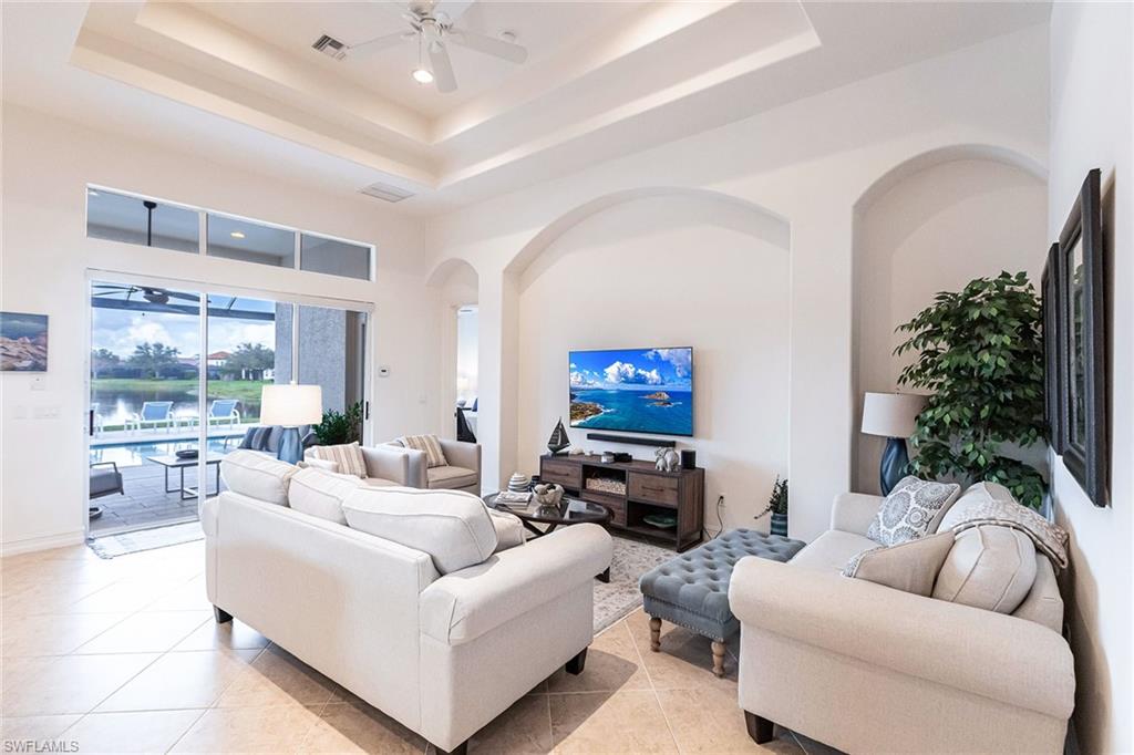 7863 Valencia Court Naples, FL 34113 - Photo 9 of 50 a living room with furniture and a large window