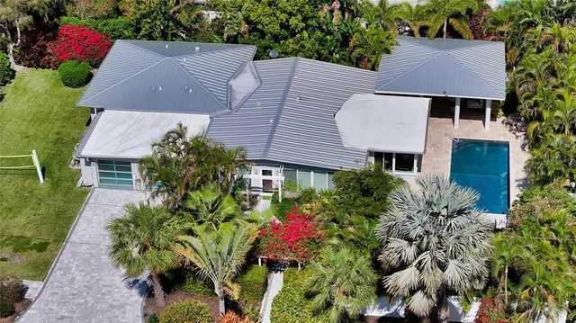an aerial view of house with yard and outdoor seating