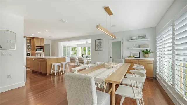 a large kitchen with stainless steel appliances granite countertop a large counter top a stove and a refrigerator