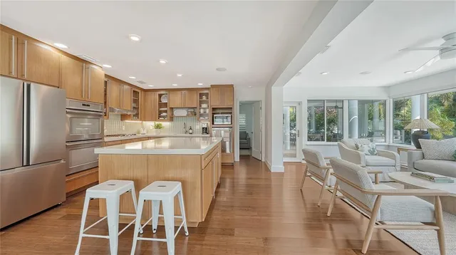 a bedroom with a large bed and a flat tv screen on dresser