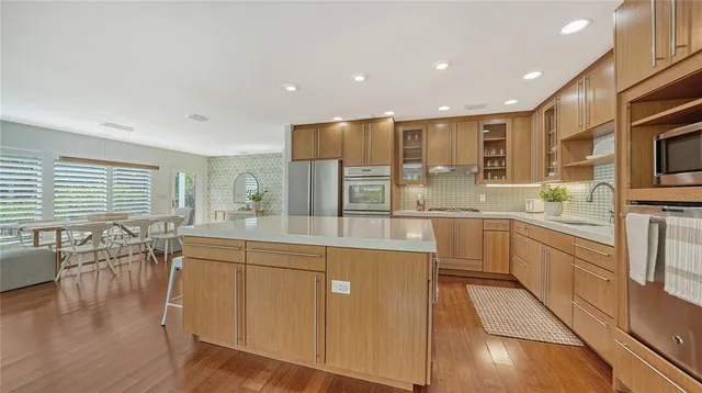 a bathroom with a double vanity sink a mirror and a bathtub