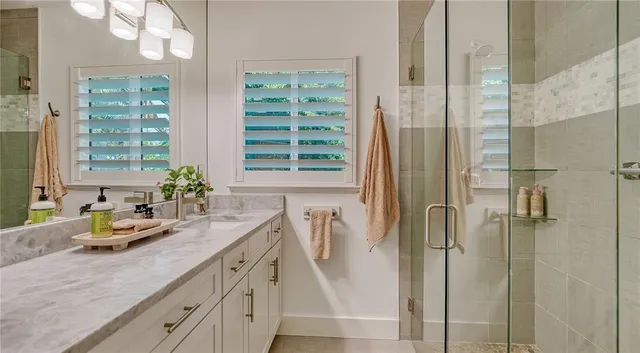 a bathroom with a sink a mirror and shower