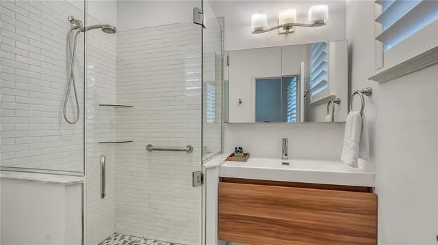 a dining room with furniture and a floor to ceiling window