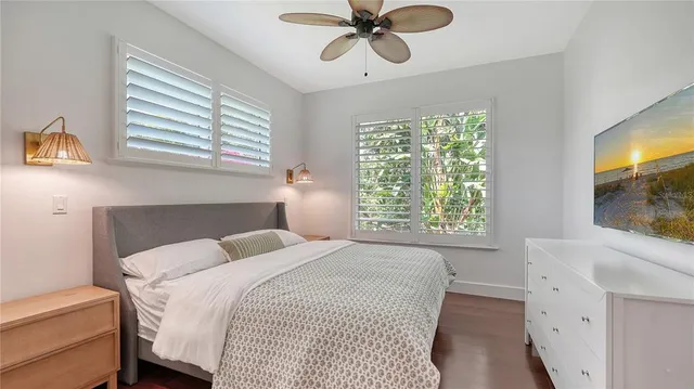 a view of a patio with table and chairs with wooden floor and fence