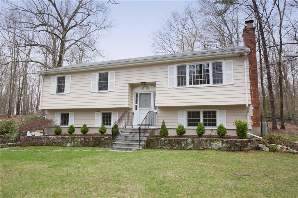 a front view of a house with a garden and plants