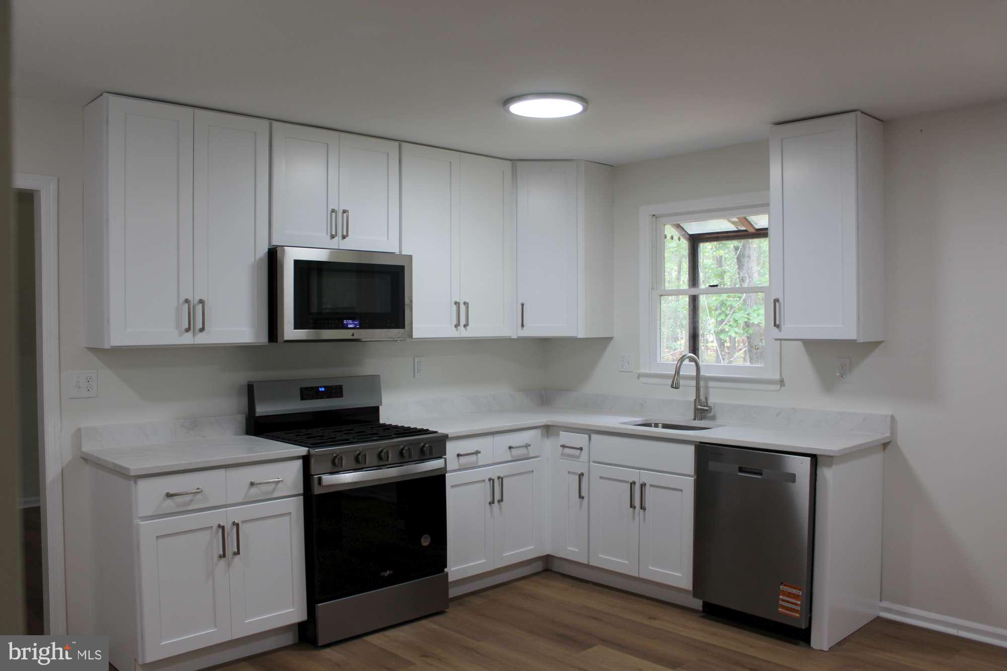 7 Deer Trail Tabernacle, NJ 08088 - Photo 8 of 31 a kitchen with white cabinets stainless steel appliances and sink