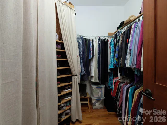 a living room with furniture gym equipment and a large window