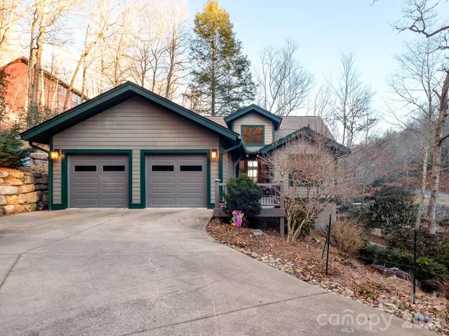 a view of a house with a wooden deck and a backyard