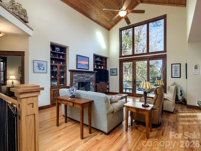 a living room with furniture and a floor to ceiling window