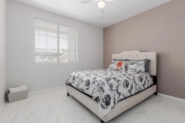 a bed sitting in a bedroom next to a window