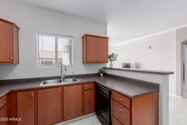 a kitchen with granite countertop a sink cabinets and window