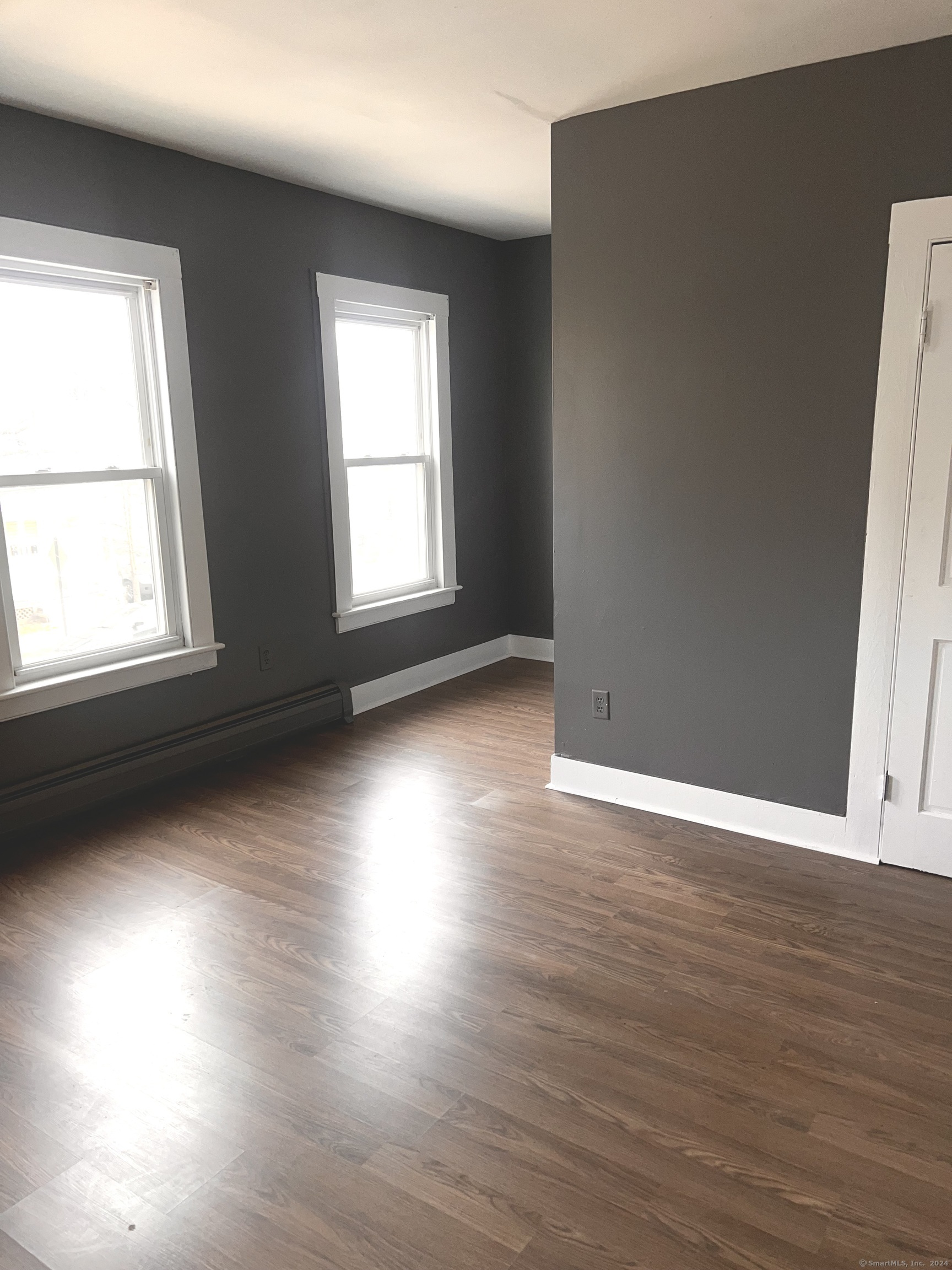 552 Winthrop Avenue New Haven, CT 06511 - Photo 11 of 12 an empty room with wooden floor and windows